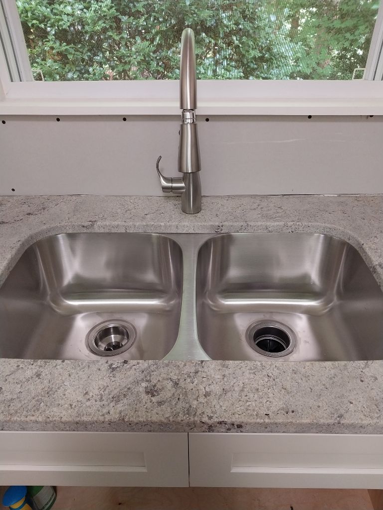 Stainless kitchen sink and faucet installed by Custom Electric and Plumbing
